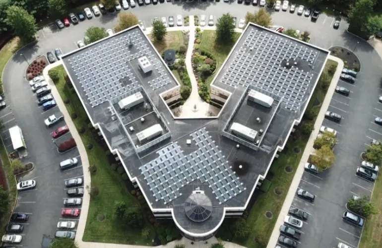 A large building with many solar panels on the roof.
